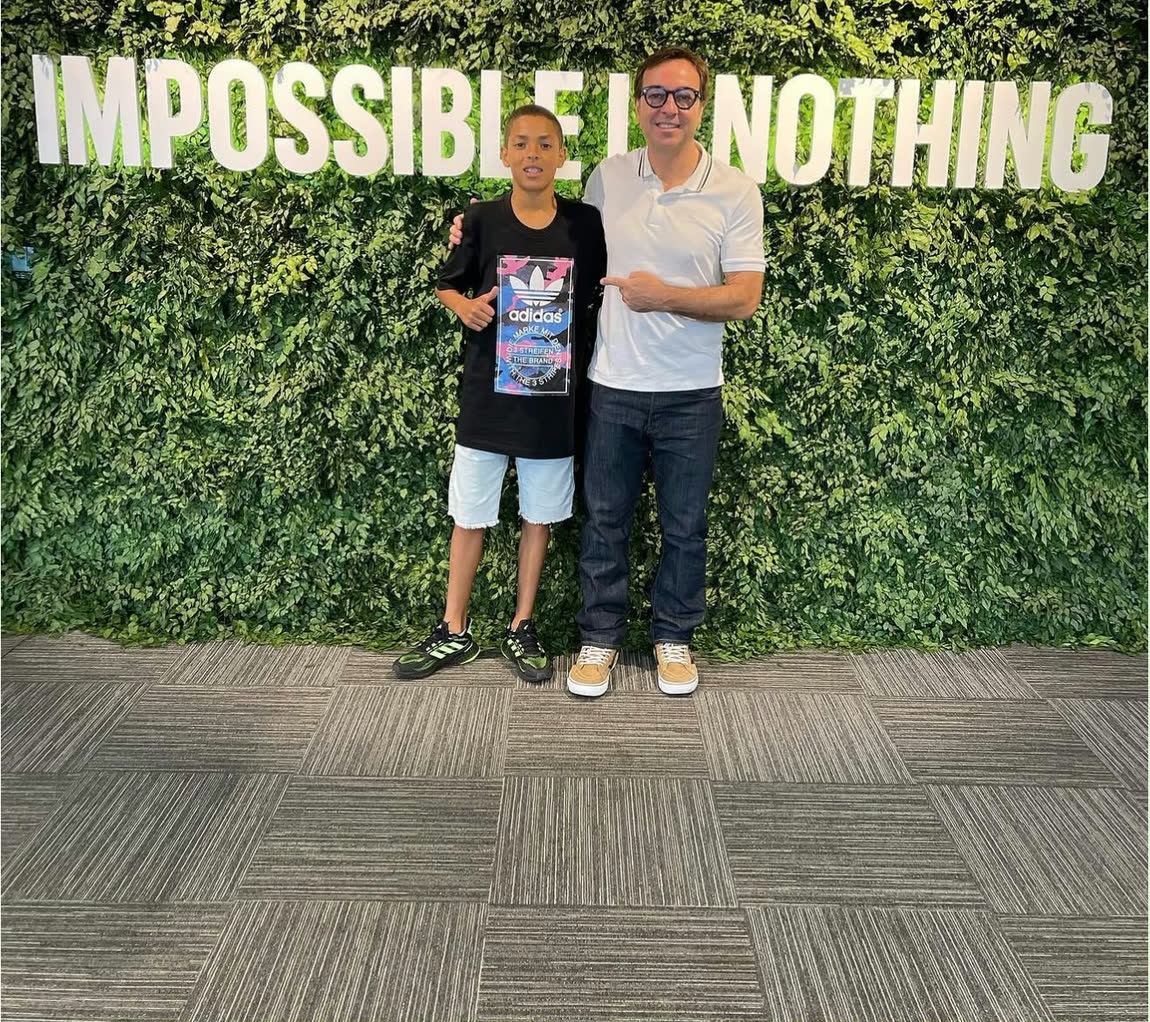 Lucas Henrique and Fabio Brancatelli in front of the IMPOSSIBLE IS NOTHING wall