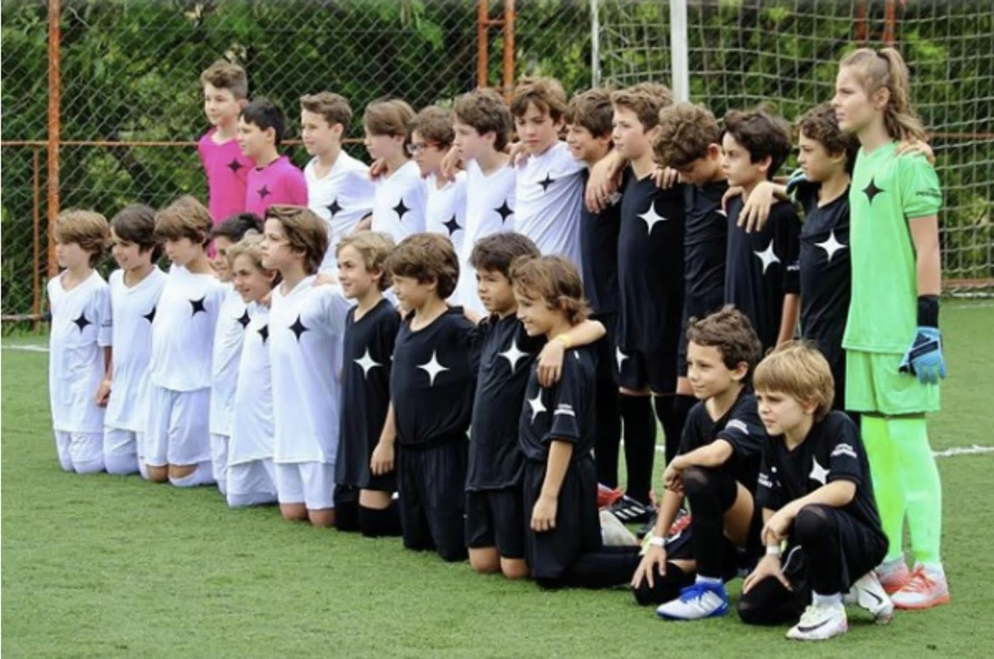 The Bicofino White and Black under-12 sides lined up on the pitch before the match