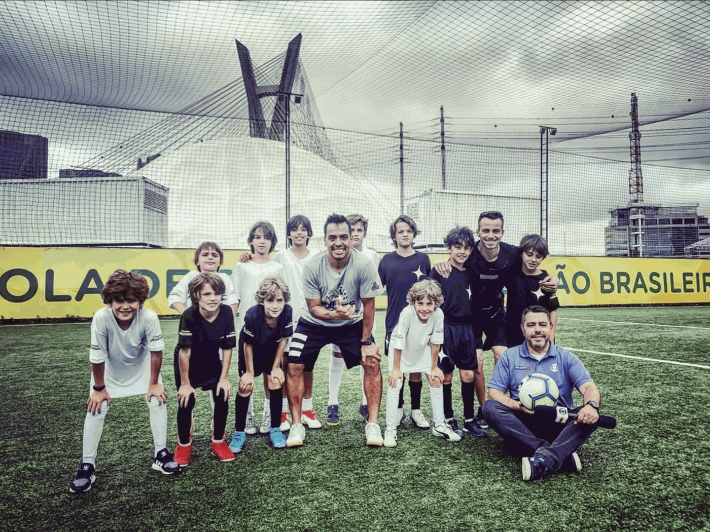 The athletes in a group photo with one of the guest stars and the press