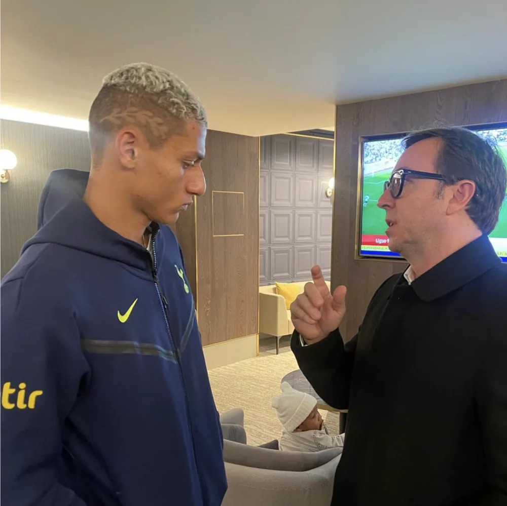 Fabio Brancatelli explaining something to Richarlison, who listens, in the Tottenham lounge